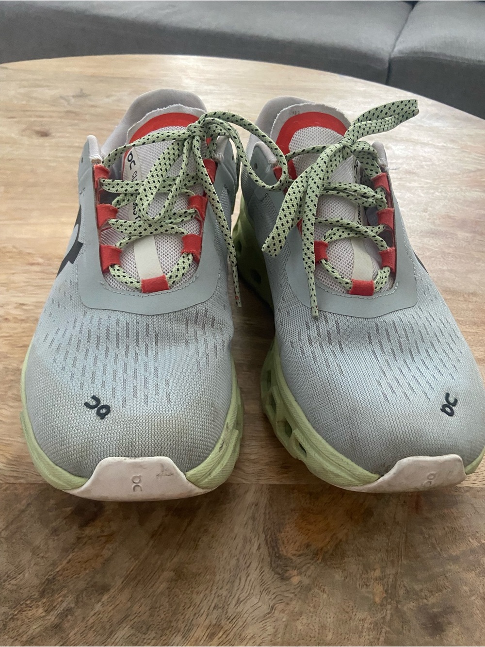 On Running Light Gray and Green Sneakers with Coral Accents